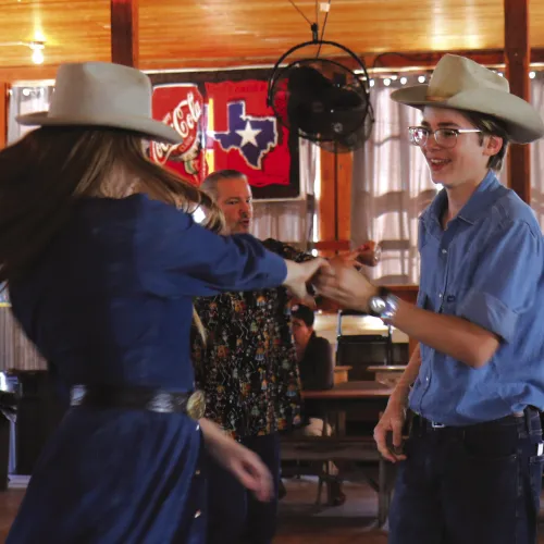 A couple spins across the floor at the Festival of Texas Fiddling inside Twin Sisters Dance Hall.