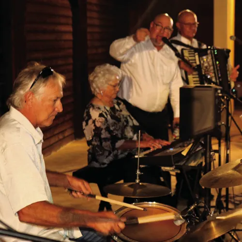 Rose Marie Baca playing keys with her son Jimmy Rohde on drums during a tribute concert to the Baca Band in 2024.